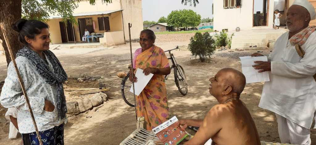 Savine Ventures representative sharing materials with senior community members in a rural setting