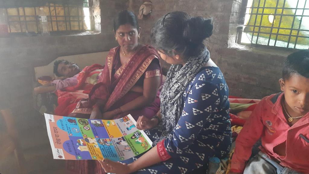 Savine Ventures conducting a  awareness session with a woman in a rural community using educational infographics