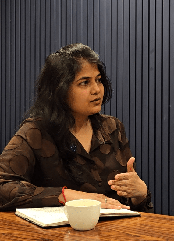 Savine Ventures podcast host, gesturing while discussing 
mental wellness topics in a studio setting